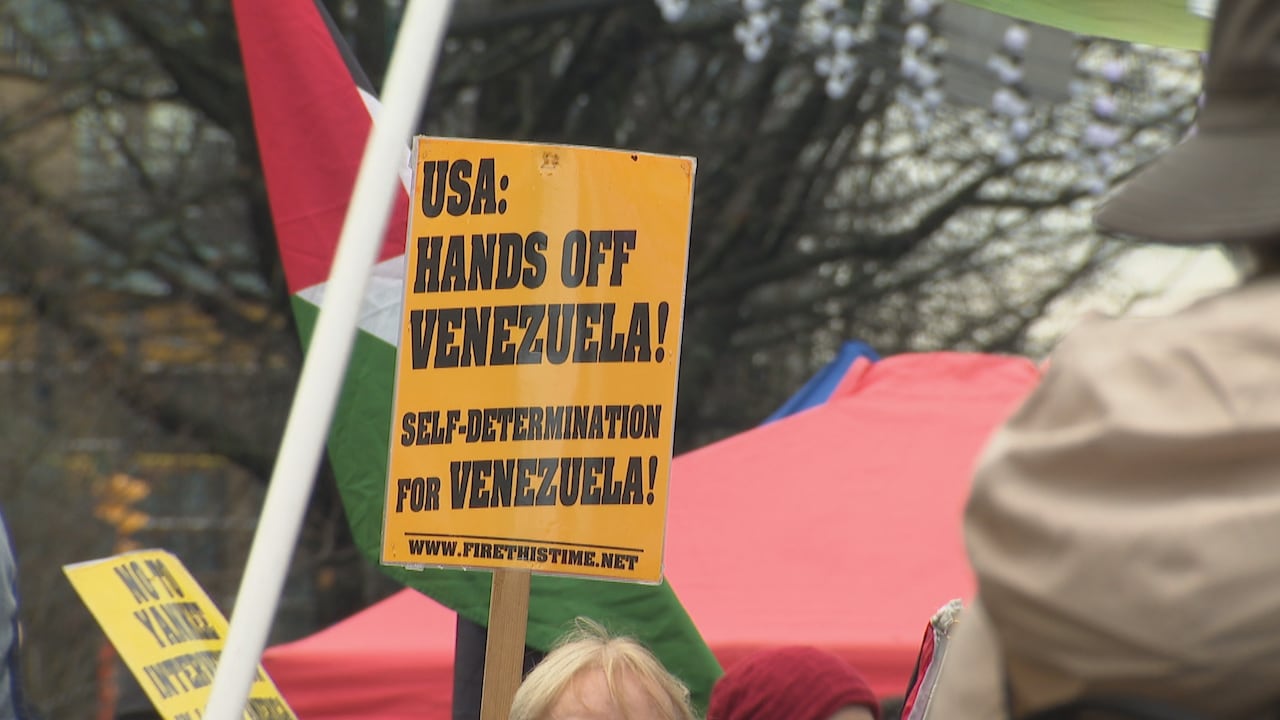 Protestors outside Vancouver Art Gallery hold signs opposing the United State's operations in Venezuela.