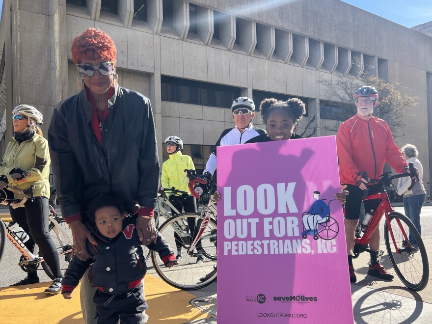 Asia Dunmore attended the World Day of Remembrance for Road Traffic Victims vigil on Nov. 16, 2026, with her son and daughter, holding a sign. Dunmore spoke in remembrance of her mother, Michelle, who was killed by a hit-and-run driver in 2023.