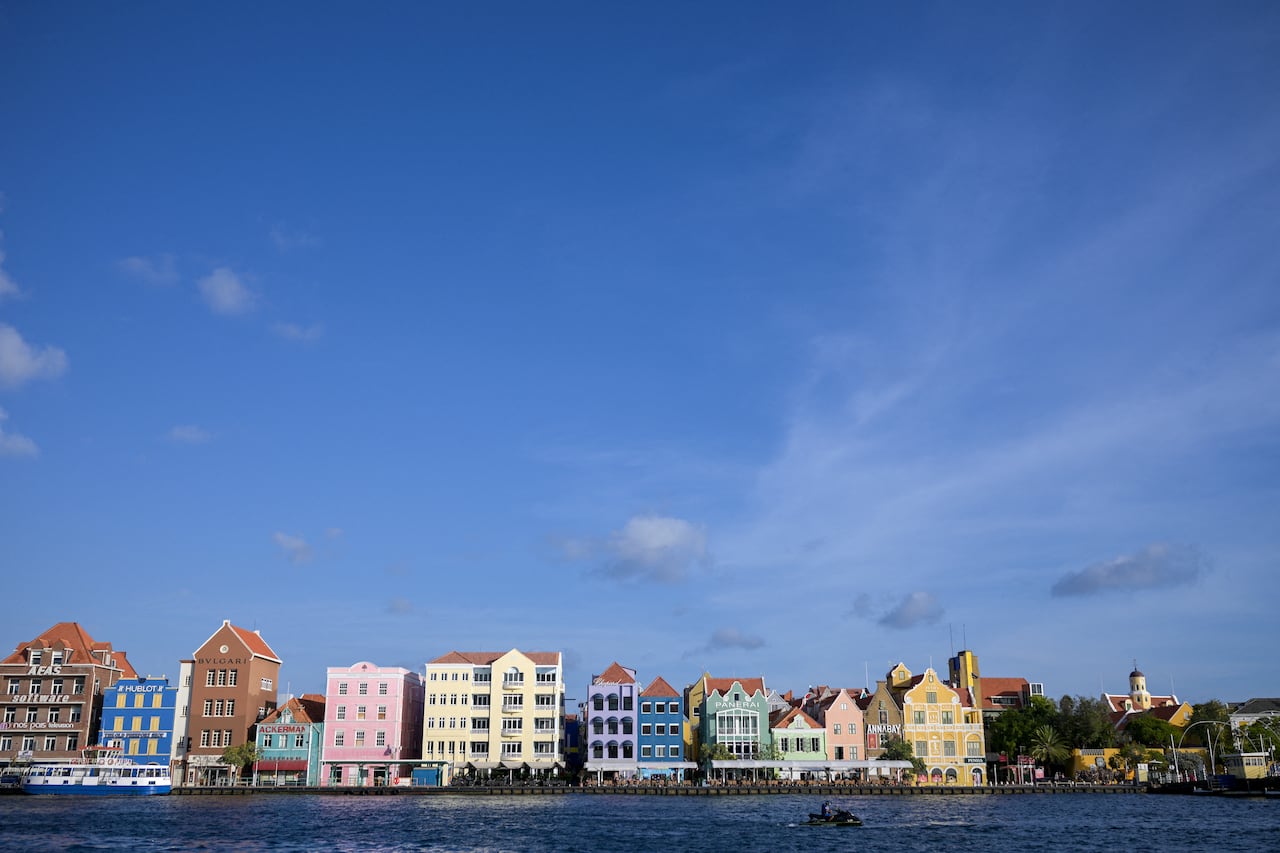 A row of bright colourful buildings set against a bright blue sky