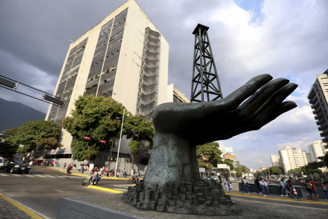 A large sculpture of a hand holding an oil drilling rig stands outside the state-run oil company Petroleos de Venezuela S.A. (PDVSA) in Caracas, Venezuela, on February 26, 2025.