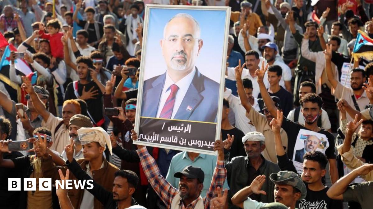 A person holds up a picture of Aidarous Al-Zubaidi during a rally in the southern port city of Aden