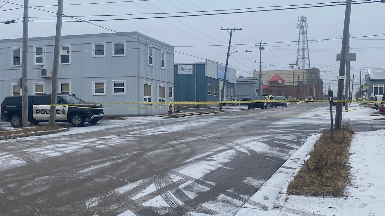 A street cordoned off with police tape.