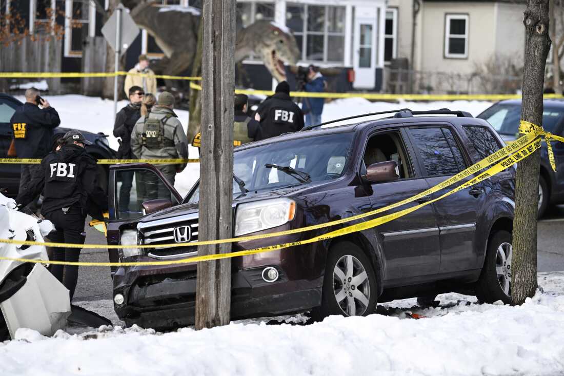 Members of law enforcement work the scene following a suspected shooting by an ICE agent during federal law enforcement operations on Wednesday in Minneapolis.