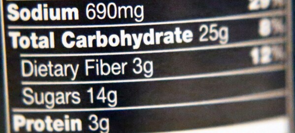 A woman looks at products in the aisle of a store as her daughter naps in the shopping cart in Waco, Texas, on Dec. 14, 2010. (AP Photo/Tony Gutierrez, File)