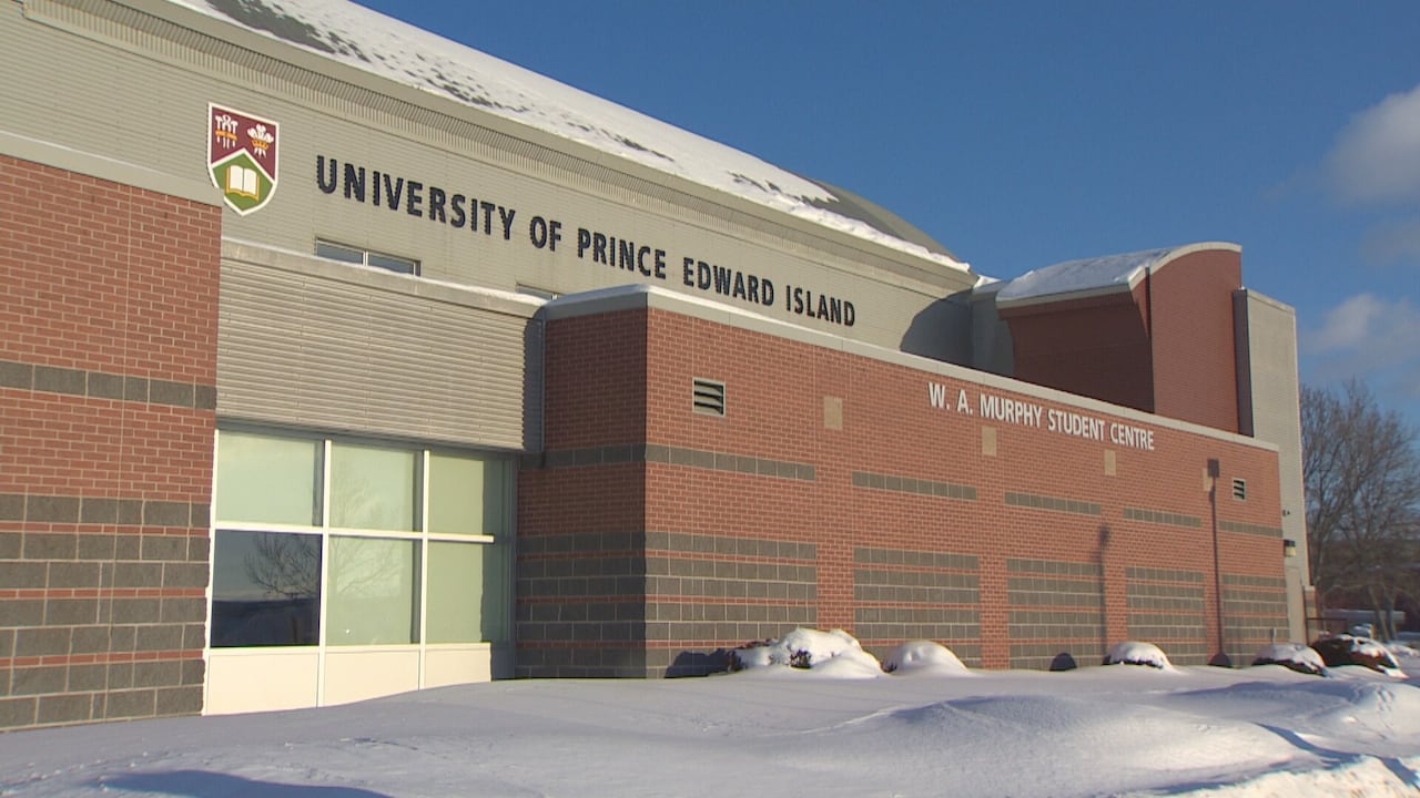 A red brick building exterior on a sunny winter day with white snow on the ground