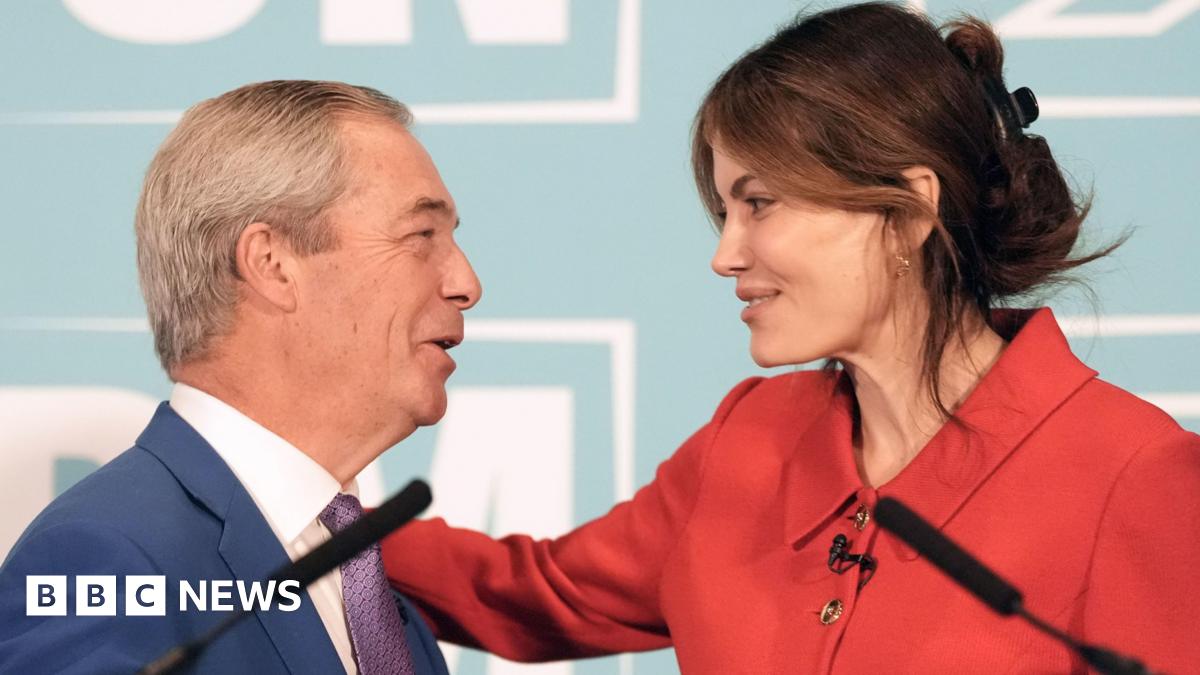 Nigel Farage and Laila Cunningham embrace at a podium in front of a press conference