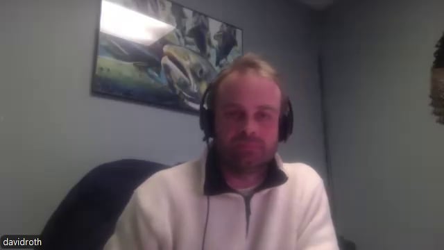 A man with short blond hair wearing a headset.