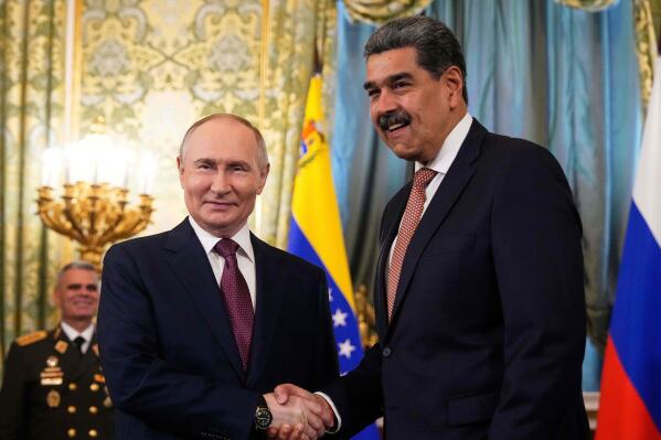 Russian President Vladimir Putin, left, shakes hands with Venezuelan President Nicolas Maduro during their meeting at the Kremlin in Moscow, Russia, Wednesday, May 7, 2025, ahead of celebrations of the 80th anniversary of the Soviet Union's victory over Nazi Germany during the World War II. (AP Photo/Alexander Zemlianichenko, file)