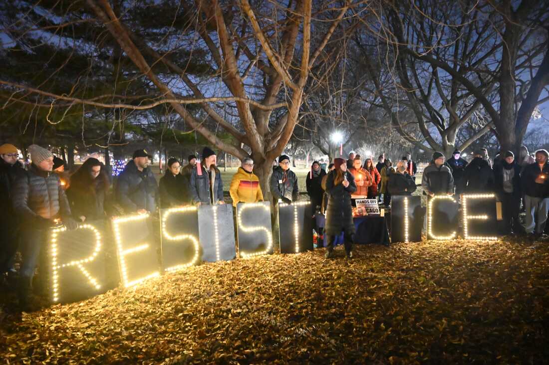 Demonstrators hold candles during an emergency vigil organized by the Ward 40+ Community Response Team at Winnemac Park in Chicago, Ill. on Wednesday.