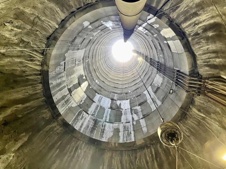 A view looking up the cylindrical main shaft of a tunnel built underground. 
