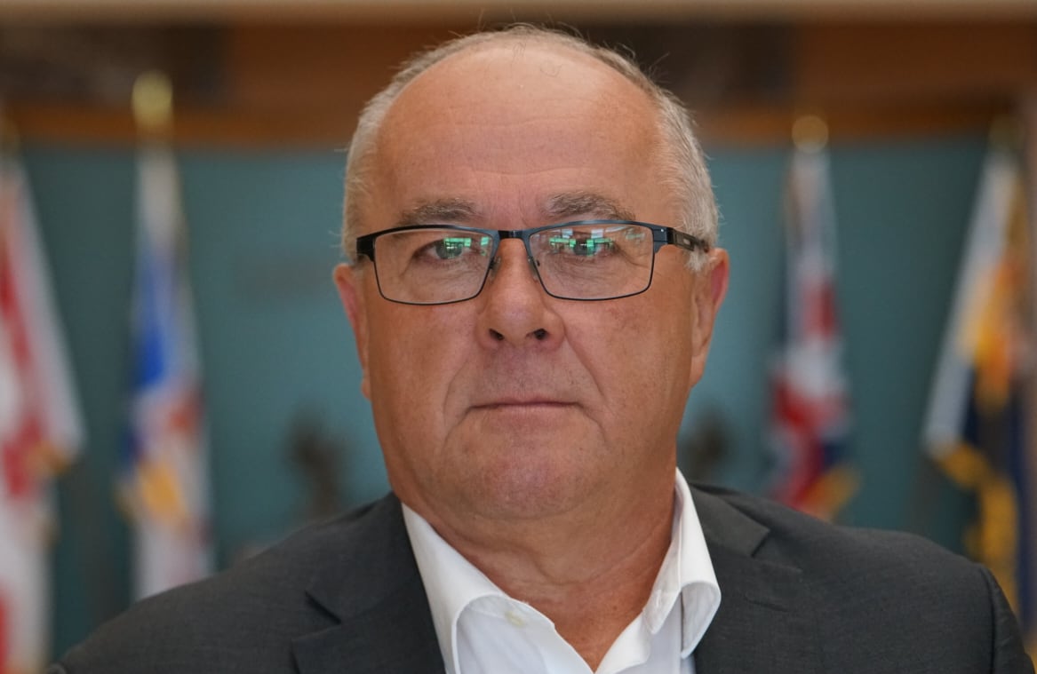 A man wearing a suit and glasses.