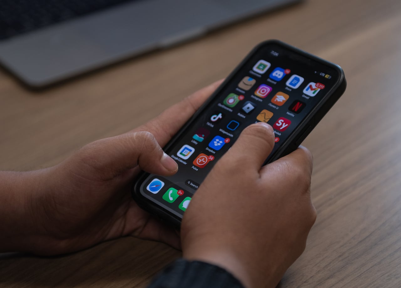 A pair of hands hold a smartphone