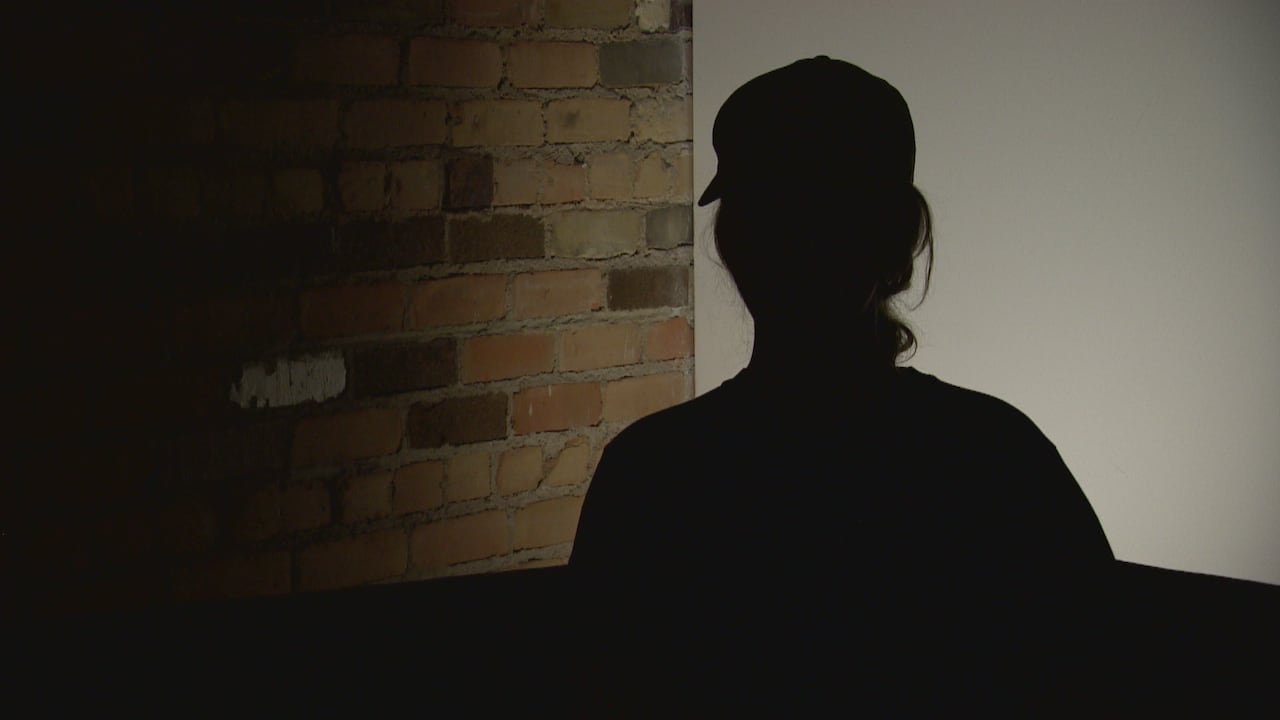 A silhouetted woman during an anonymous interview.