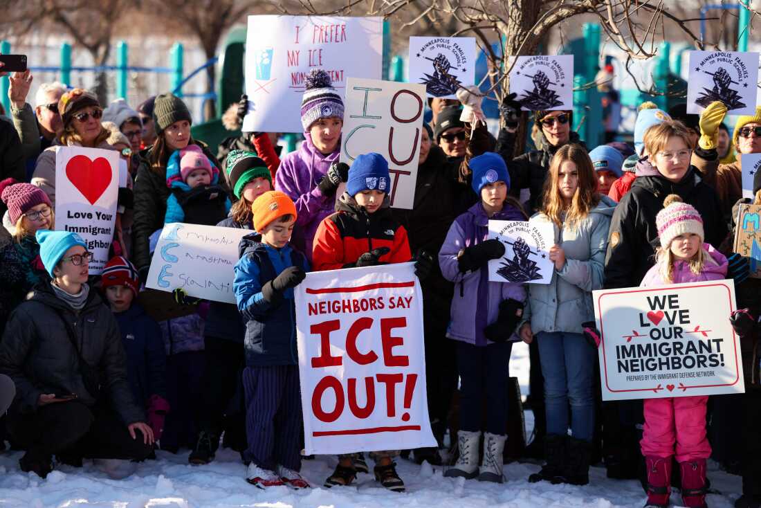 People observe a moment of silence in Minneapolis, Minn., at a news conference organized by the group Minneapolis Families for Public Schools. 