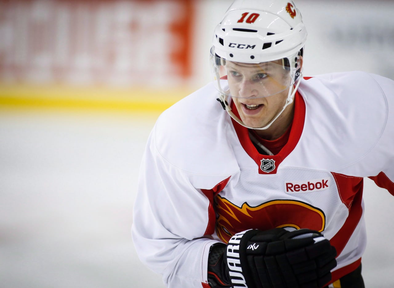 A hockey player on ice in an arena.