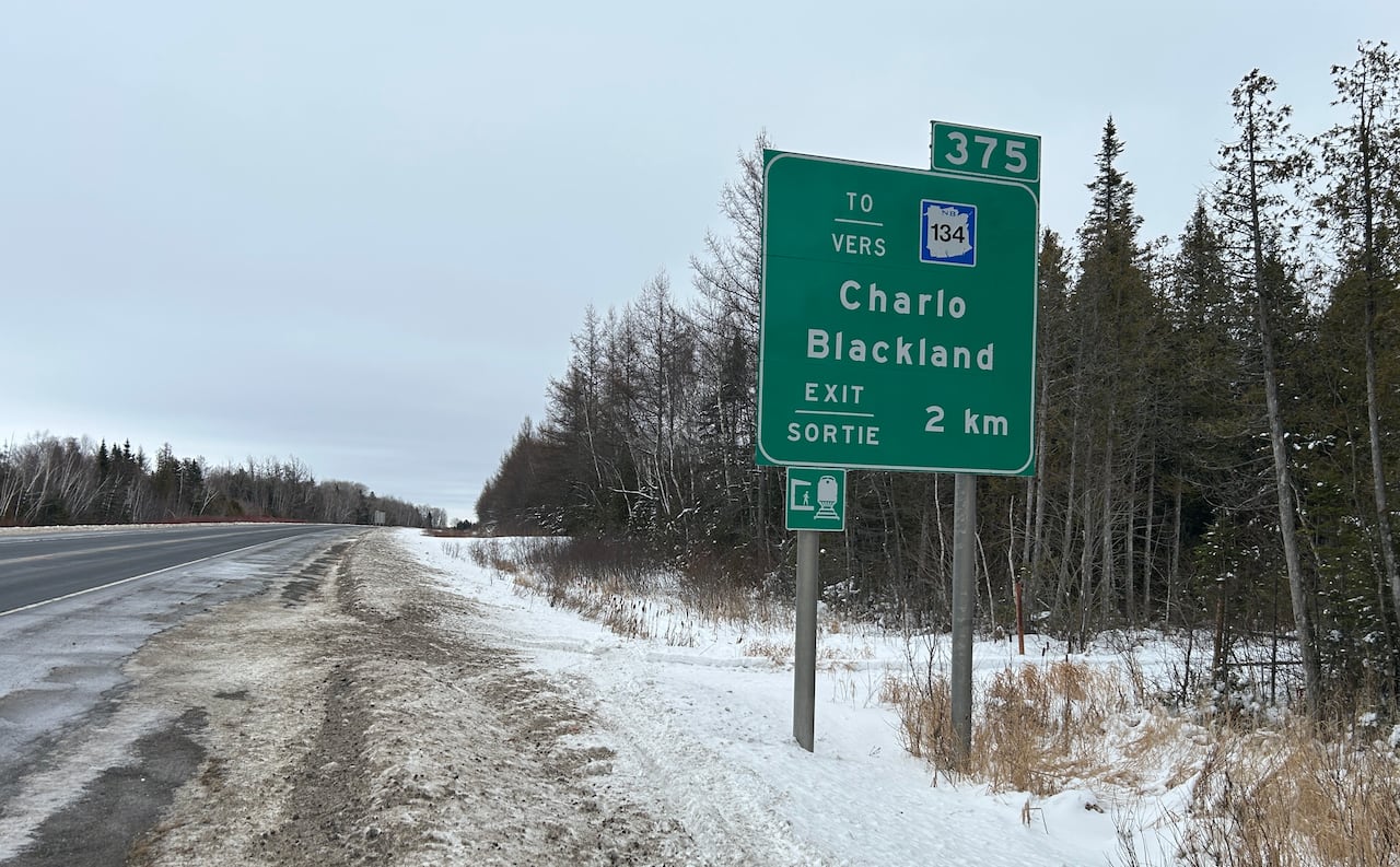 Highway exit sign on the side of a highway.