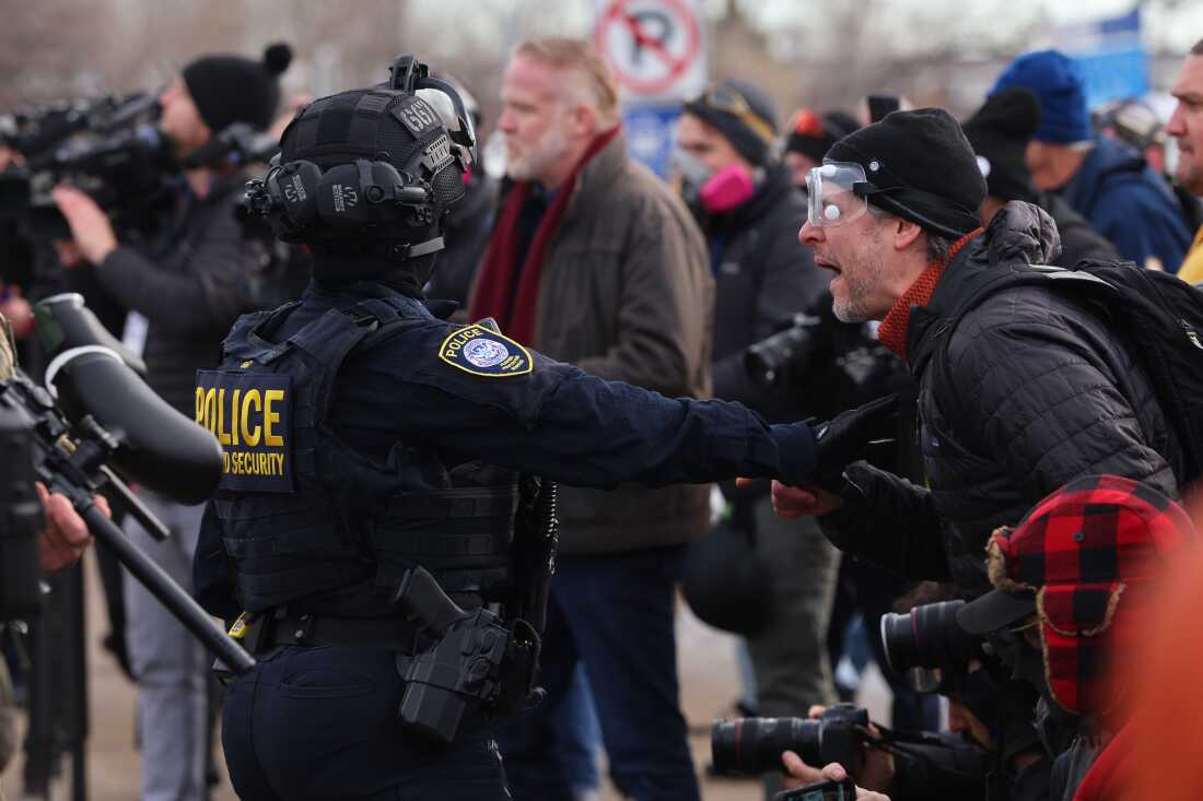 Protesters confront law enforcement outside the Bishop Henry Whipple Federal Building in Minneapolis, Friday, Jan. 9, 2026.