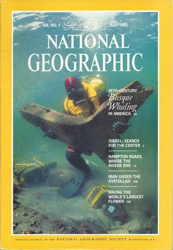 A cover of a magazine of a man in scuba gear underwater holding something u-shaped.