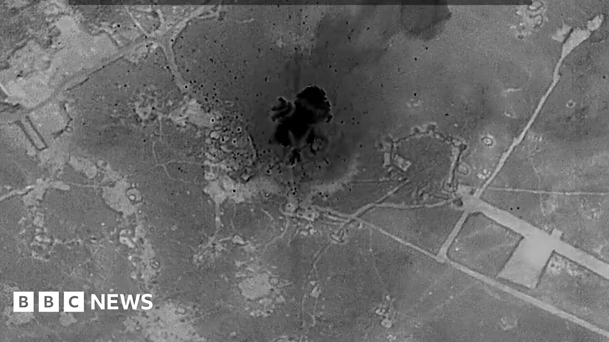 Screenshot from a video posted by US Central Command, showing an explosion in an area of land, with the word "unclassified" written across the top