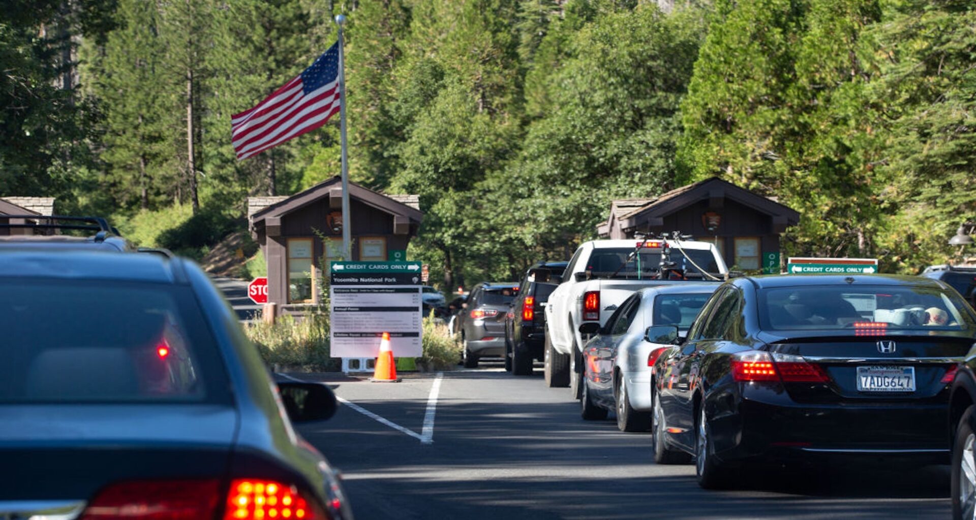 A long line of cars creeps slowly entrance of Yosemite National Park