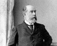 A black and white photo of a man in a suit.