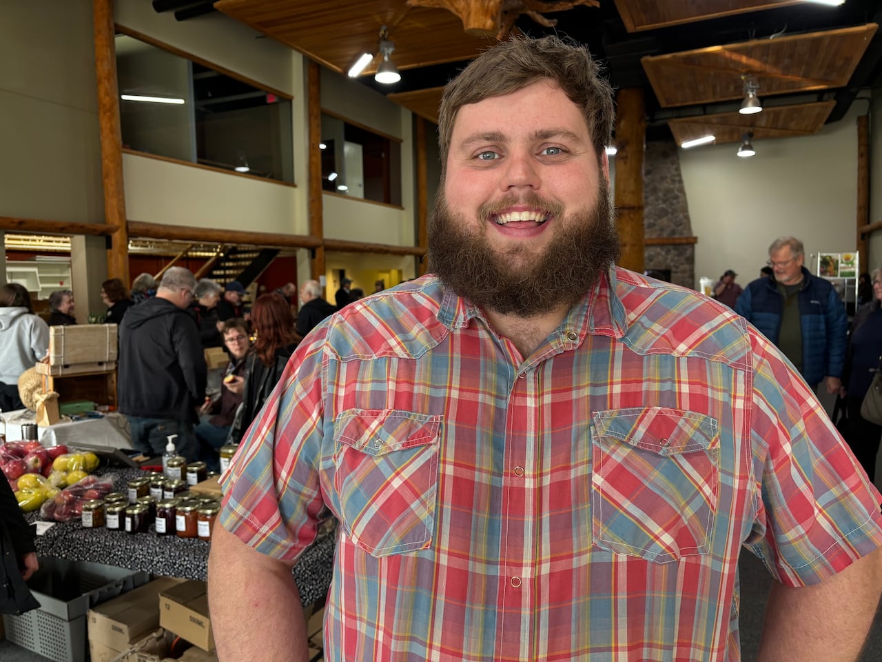 A man in a red and blue plaid shirt.