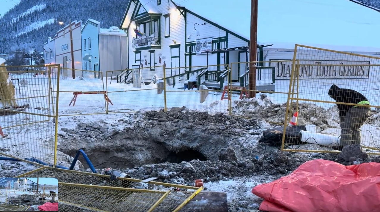 A man working on a dug up road