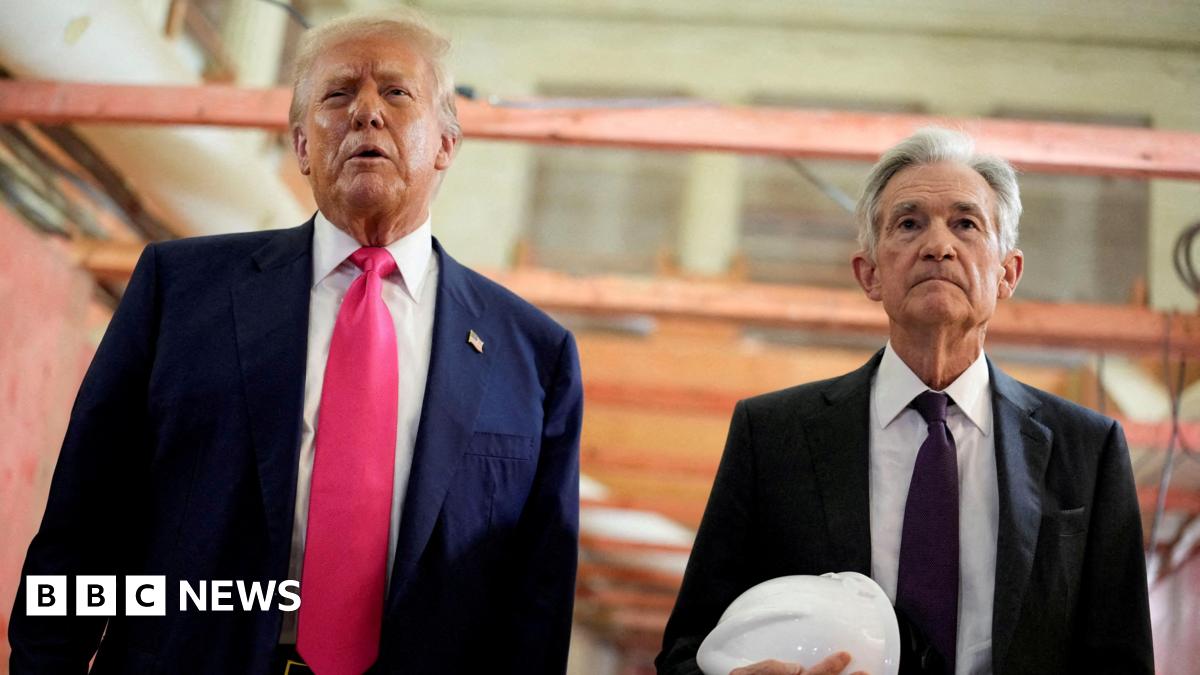 Donald Trump appears next to Jerome Powell, who is carrying a white hard hat, during a visit to the Federal Reserve building as it undergoes renovations.
