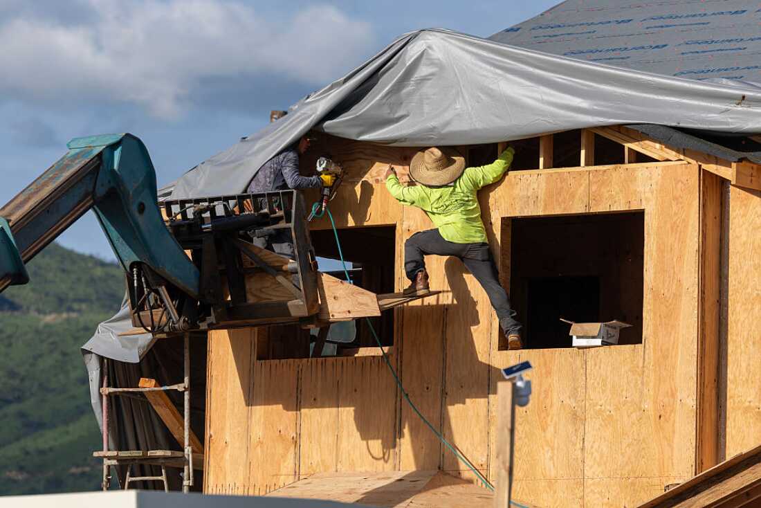 Construction workers build a home in the Palisades fire zone on the one year anniversary in Pacific Palisades Tuesday, Jan. 6, 2026.