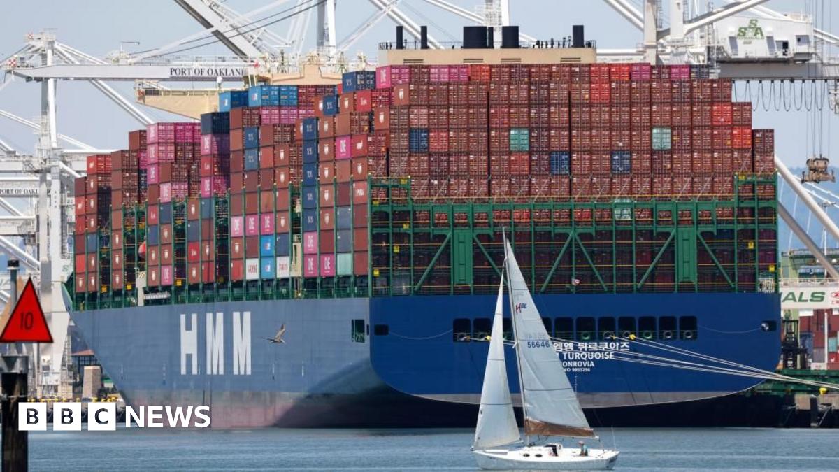 A sailboat sails past a container ship at the Port of Oakland in Oakland, California, USA, 14 July 2025.