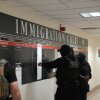 U.S. Immigration and Customs Enforcement agents look over lists of names and their hearing times and locations inside the Federal Plaza courthouse in June 2025 in New York.