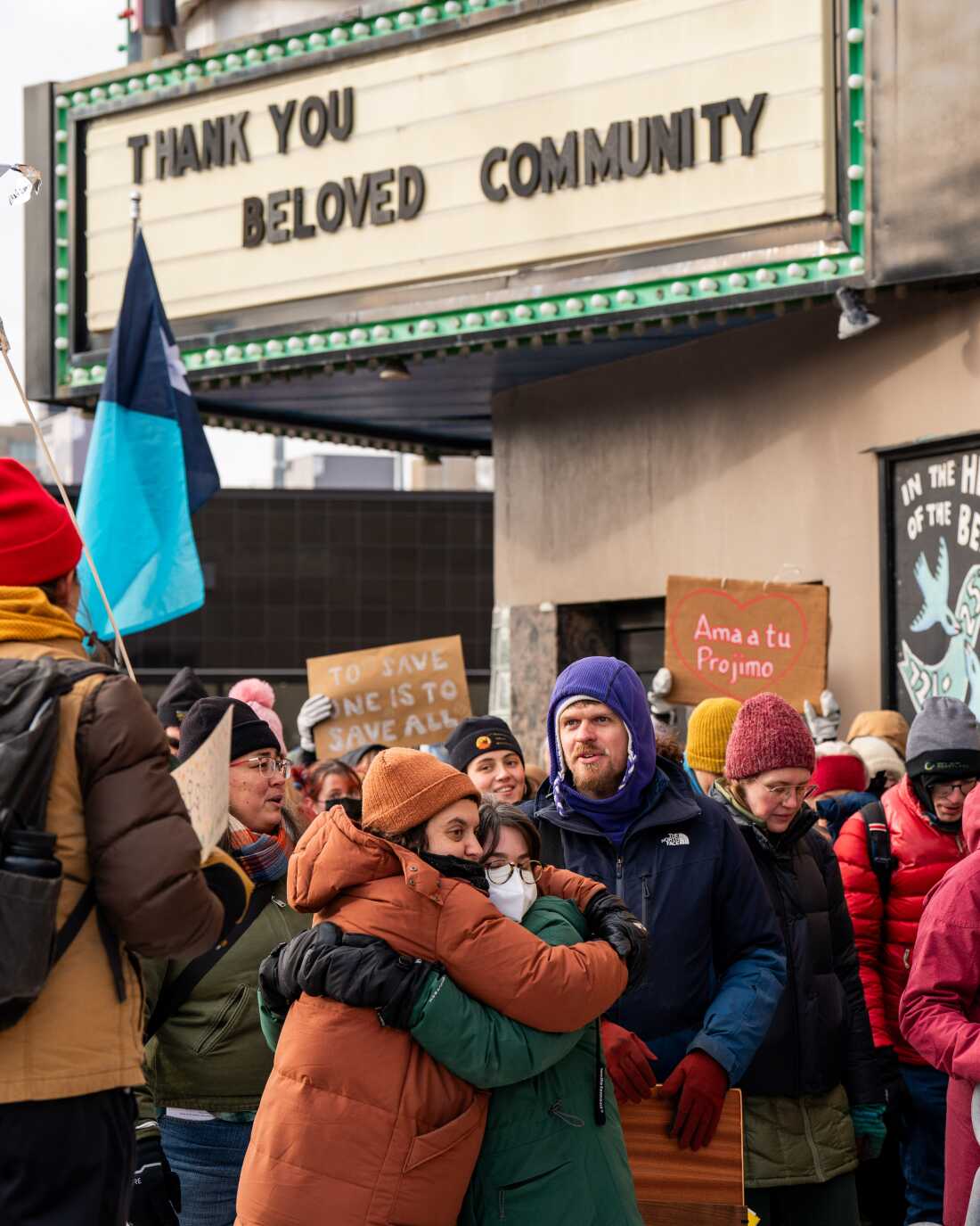 Participants in a singing vigil share a hug on the march through the Phillips neighborhood in Minneapolis on Sunday.