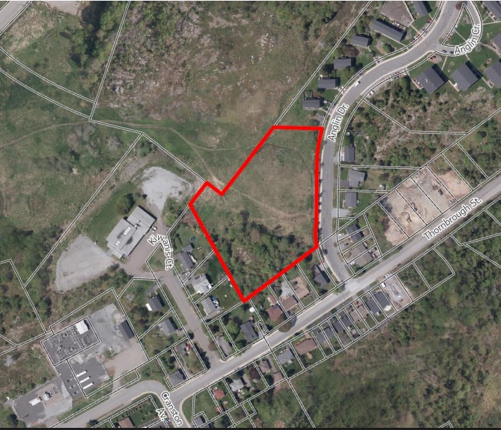 Aerial google map shot of neighbourhood with an area outlined in red showing where development will be.