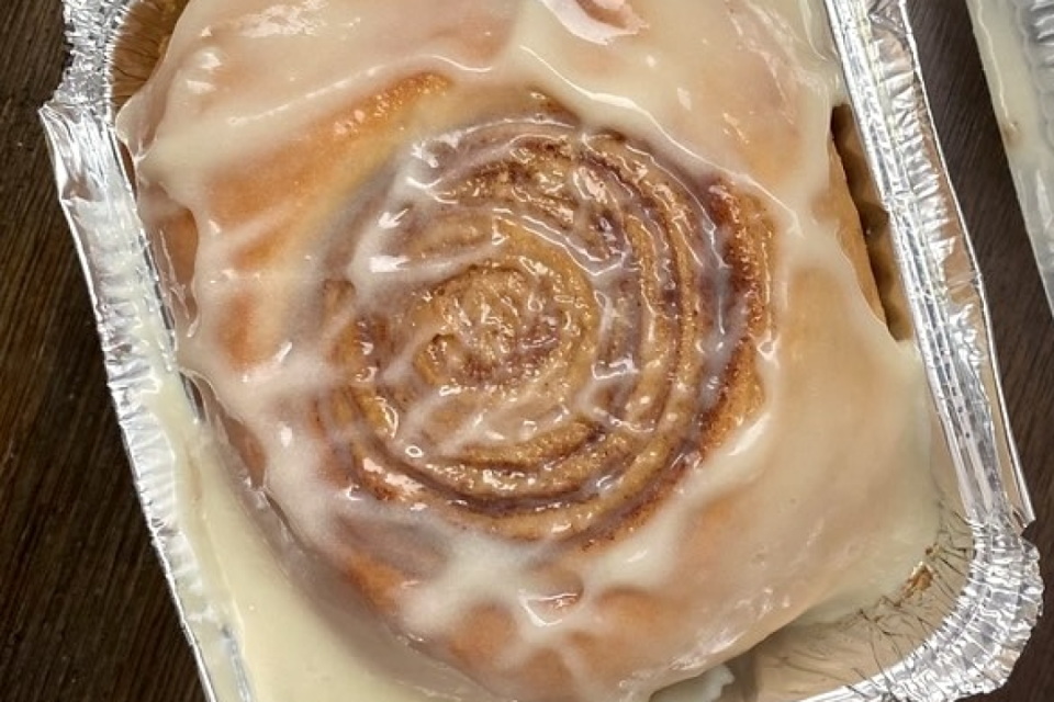 sweet gooey cinnamon bun doused in a creamy icing