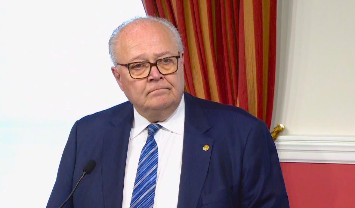 A man is pictured wearing a tie.