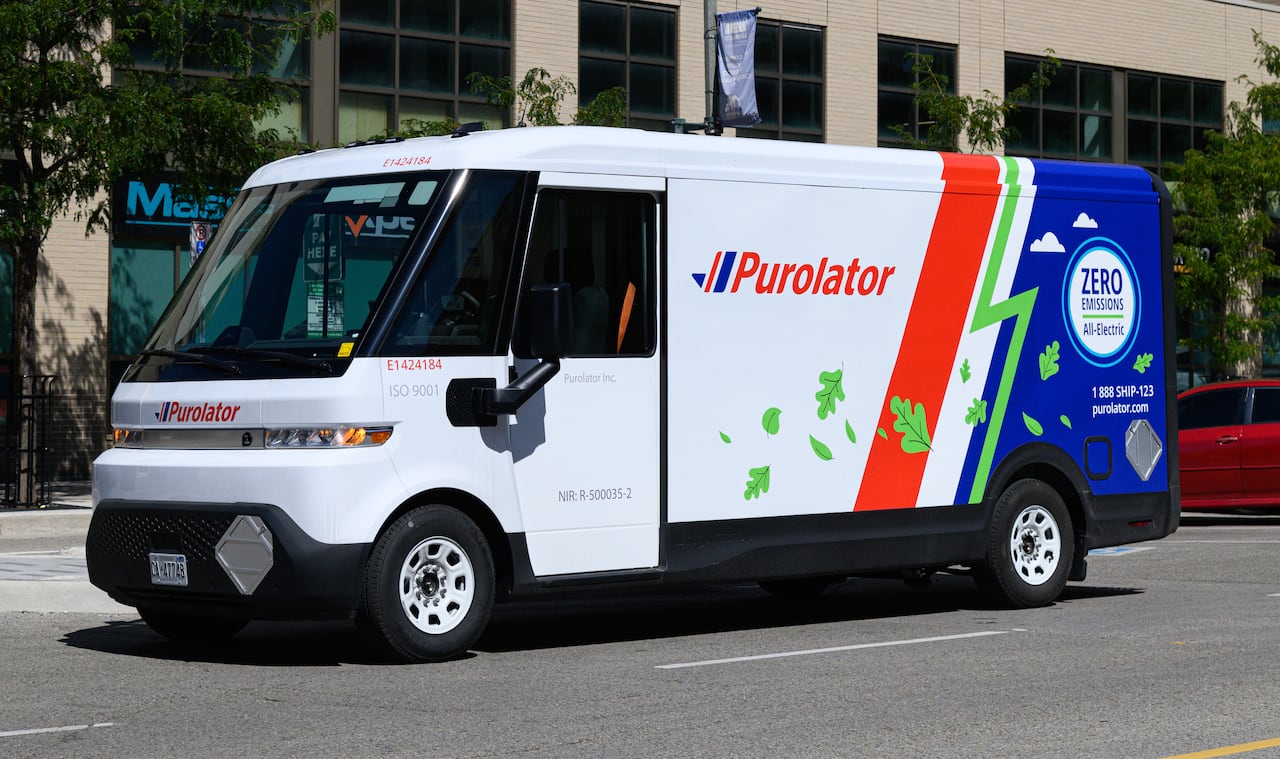 A large delivery van with the words 'Purolator' along its side.