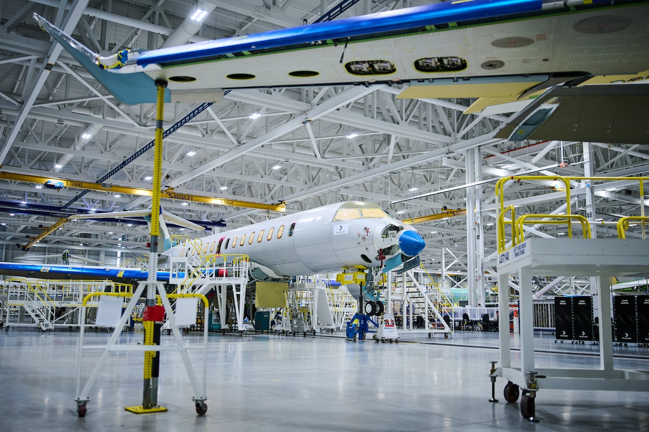 A jet being assembled in a hangar.