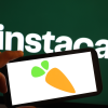 The Instacart logo is displayed on a computer monitor and phone.