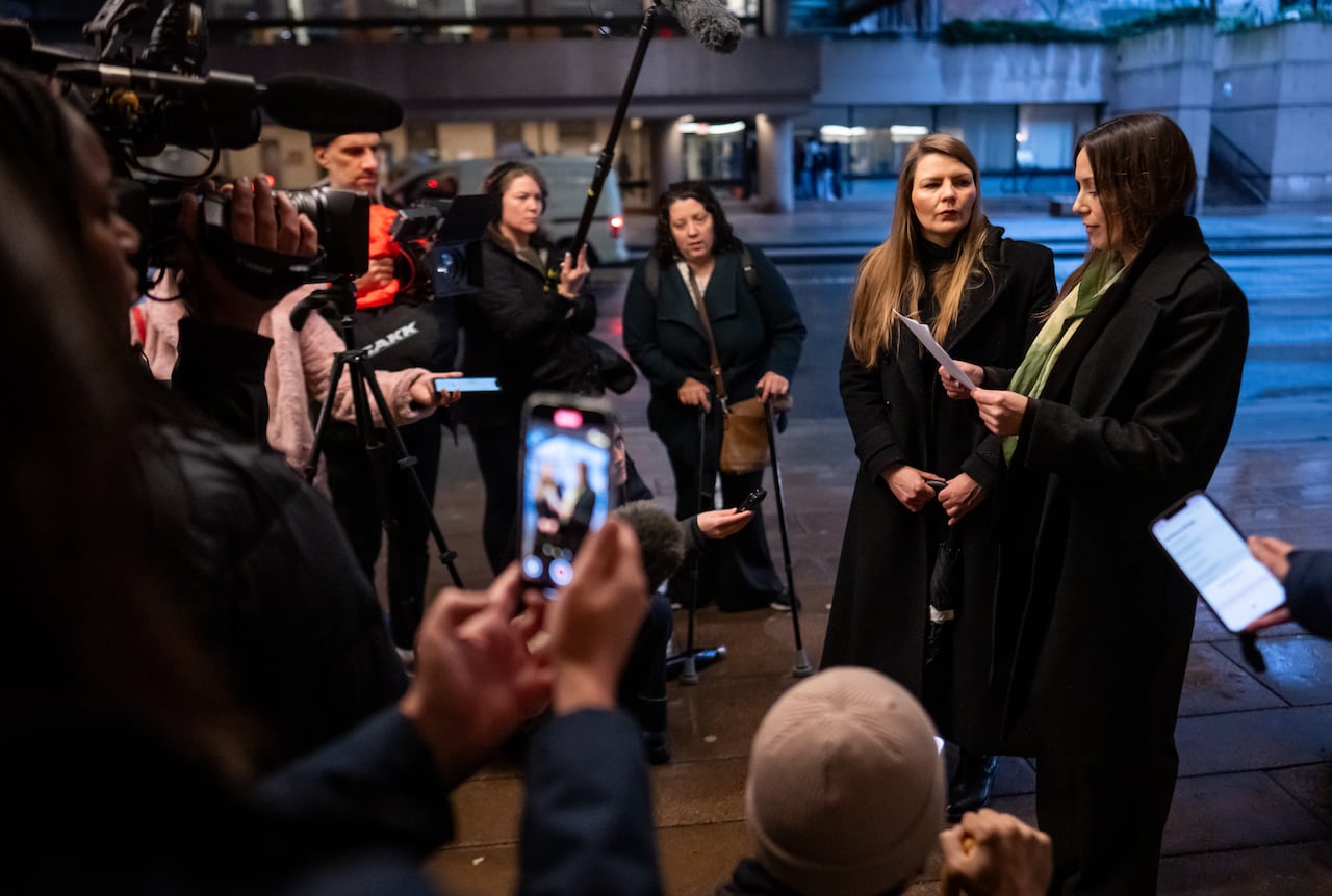 two women surrounded by media