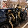 Federal immigration officers get in a car as they prepare to deploy tear gas at a protest Monday in Minneapolis.