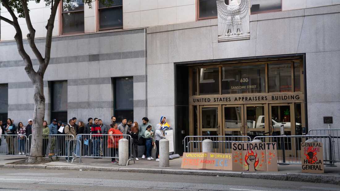 People wait outside immigration court in October 2025 in San Francisco.