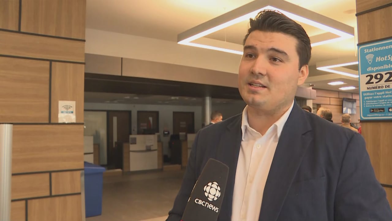 A man speaking with a reporter