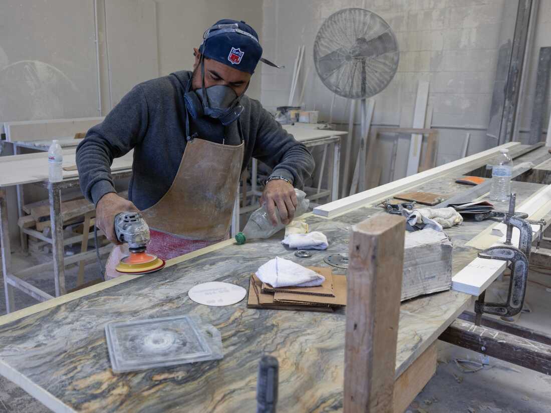 Sun Valley, CA: A stone countertop fabricator wears a mask to help protect against airborne particles which can contribute to silicosis at a shop in Sun Valley, CA. (Brian van der Brug / Los Angeles Times via Getty Images)