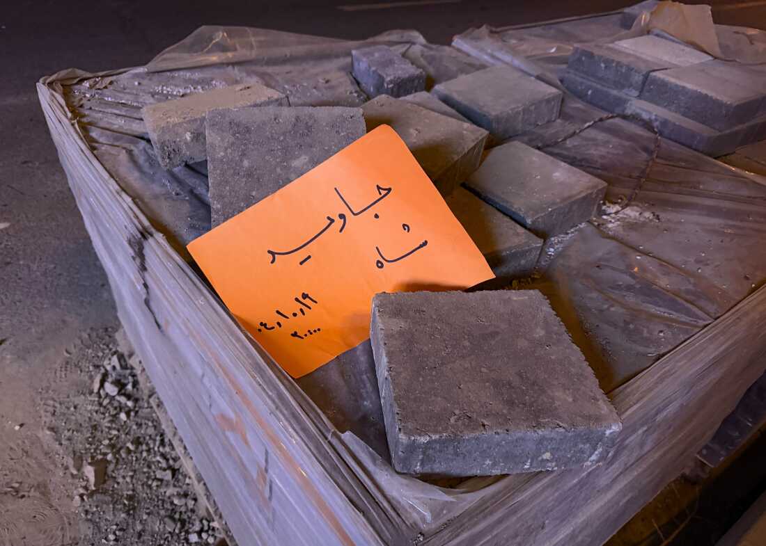 In this photo obtained by The Associated Press, a placard is placed on bricks that reads in Farsi, "Long live the Shah," referring to the Pahlavi dynasty that was toppled in the 1979 Islamic Revolution, during an anti-government protest in Tehran, Iran, Jan. 9.