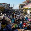 Residents gather amid debris in the aftermath of Hurricane Melissa on a street in Jamaica in October 2025.
