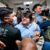 A Paraguayan woman whose relative was detained by federal agents scuffles with officers in the halls of immigration court at the Jacob K. Javits Federal Building in New York City in July.