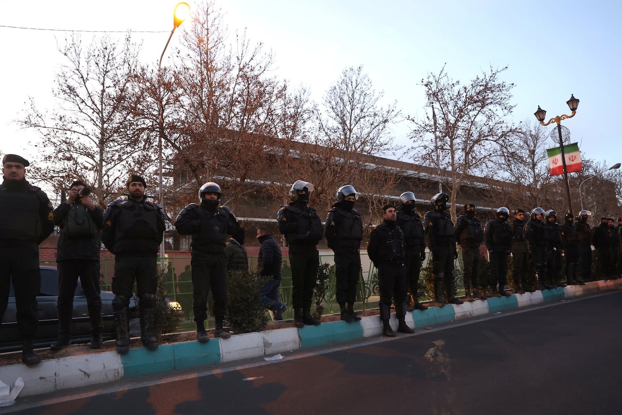 Members of the Iranian police stand guard at a protest in front of the British embassy following anti-government protests in Tehran, Iran, January 14, 2026. 