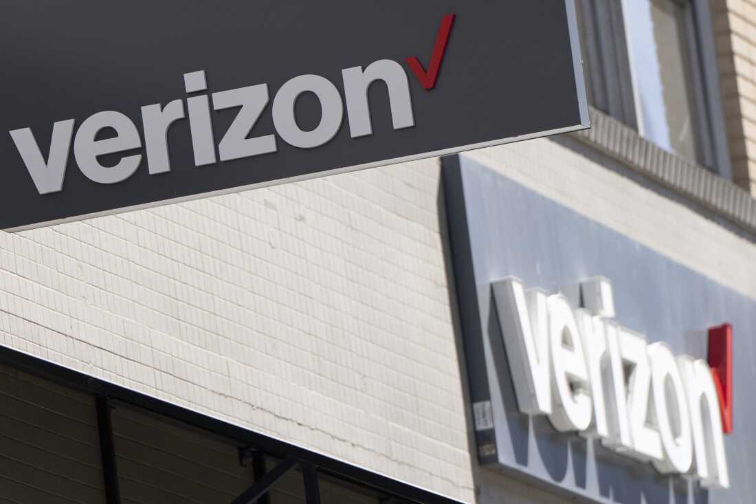 Signs are displayed outside a Verizon retail location in Portland, Oregon, on May 14, 2024.