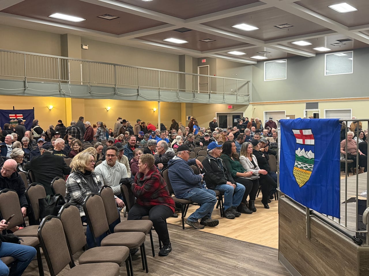 A crowd of people sitting in a hall.