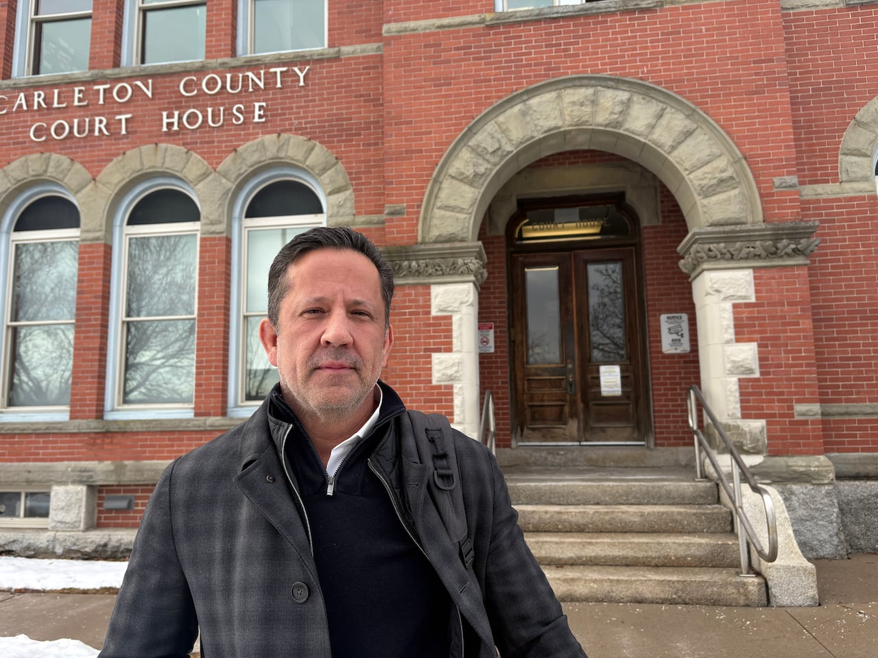 TJ Burke stands outside the courthouse in Woodstock, N.B.